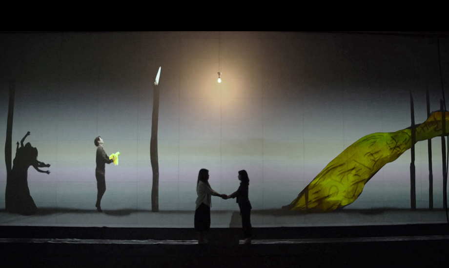 Empathy — two people holding hands before the illuminated projection